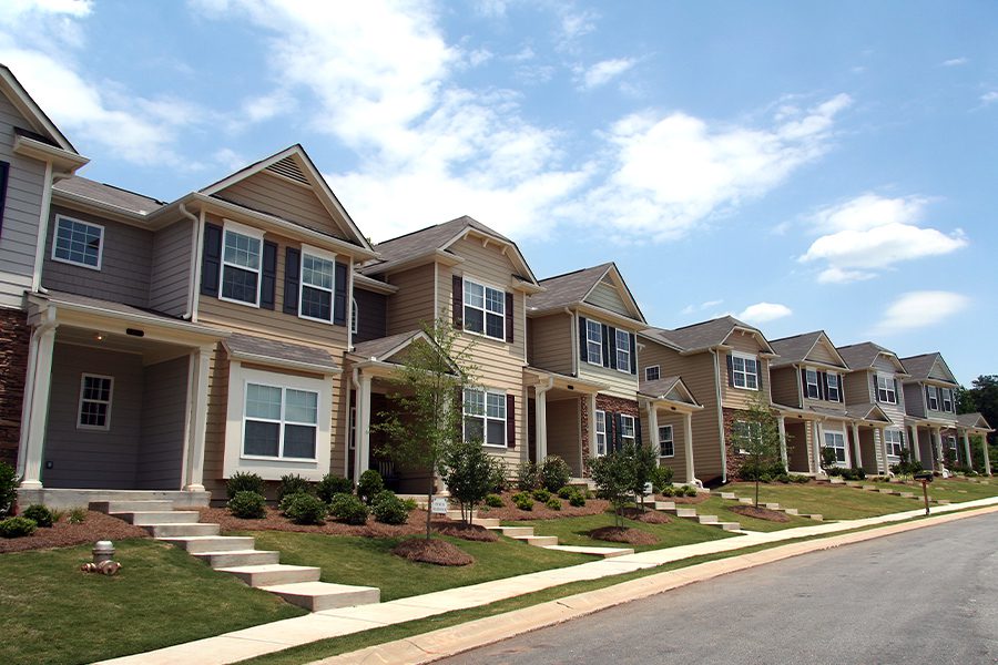 Homeowners Association Insurance - A Row of Newly Constructed and Professionally Landscaped Townhomes on a Bight Sunny Day